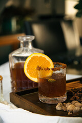 Mulled cider with whole Cha&iuml; spices in vintage glass and jar