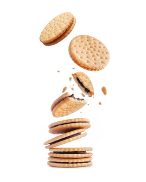 Whole and crushed crispy cookies with chocolate filling. Stack of crispy cookies isolated on a white background