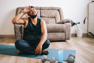 A fat man in sportswear feeling tired after practicing yoga - obrazy, fototapety, plakaty