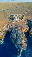 Aerial panoramic view of Punta Nati Lighthouse at north coast of Menorca (Balearic Islands)