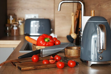 Fresh vegetables for salad in a modern wooden kitchen