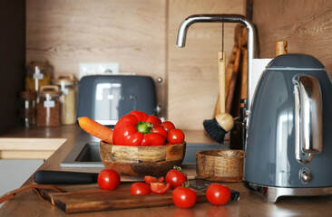 Fresh vegetables for salad in a modern wooden kitchen