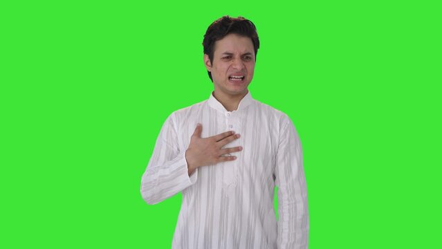 Sick Indian man having acidity attack Green screen