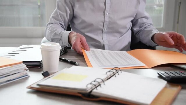 Businessman taking and opening a folder