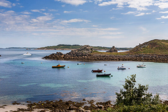 The anchorage of Porth Conger, St. Agnes, Isles of Scilly, Cornwall, England, with the island of Gugh opposite and St. Mary's in the distance