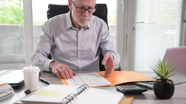 Businessman opening a folder at office