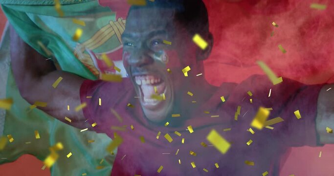 Animation of gold confetti over cheering african american male sports fan waving flag of portugal