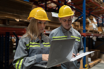 Male and female warehouse worker working and discussing in warehouse storage. Warehouse workers inspecting quality of barcodes on shelves pallet