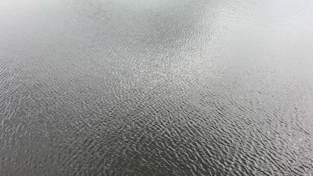 Dark river water rippled surface.