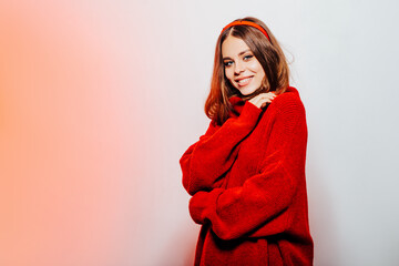 happy girl in a stylish red woolen sweater   