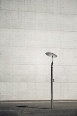 Minimalistic architecture. Street lamp cast shadow against grunge concrete building