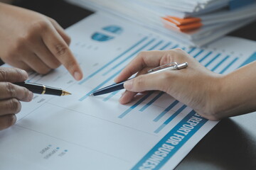 Financial analysts analyze business financial reports on a digital tablet planning investment project during a discussion at a meeting of corporate showing the results of their successful teamwork.