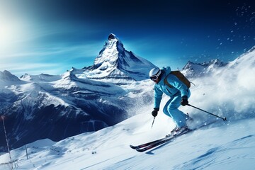A man skiing down a snow-covered slope - obrazy, fototapety, plakaty