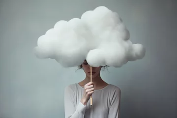 Fotobehang A sad woman hidden behind a cloud, concept of loneliness and depression © Virginie Verglas