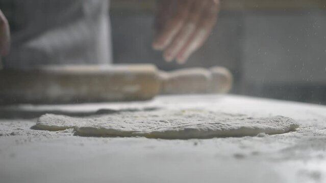 closeup shot of kneading dough for pizza. traditional italian flour to make Neapolitan-style pizza