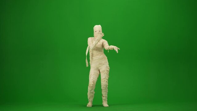Scary mummy wrapped in bandages dancing the Macarena dance. Green screen isolated chroma key. Mock up, workspace for your promotion clip or advertisement. Full length.