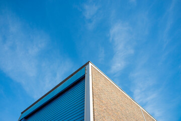 Fototapeta na wymiar industrial estate construction warehouse unit with roller door against a blue sky