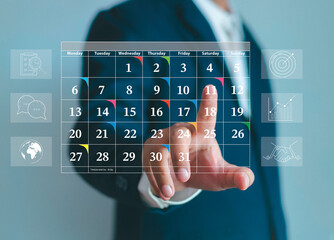 Appointment calendar reminder for schedule, agenda and event planner organize and schedule activities. Businessman uses hand to schedule calendar to mark target date on colored paper. - obrazy, fototapety, plakaty