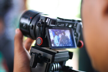  a videographer is recording an activity at an event as seen from the video camera's view finder