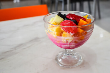 fruit ice, mixed ice (es buah) refreshing drink with ice cubes with fruit, in a serving glass