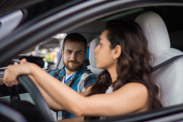 Young couple enjoying summer trip while driving the car while fastening seat belts. Travel adventure drive, happy summer vacation concept