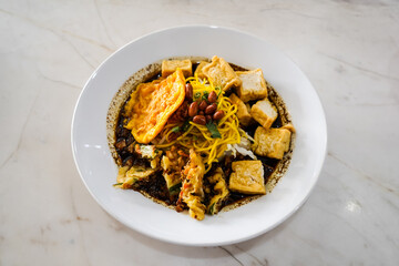 Kupat Tahu, with peanut sauce, Typical warm rujak snacks consist of rice cake, tofu and vegetables with spicy skinned peanuts and crackers on top. traditional Indonesian food, Central Java