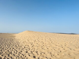 Sandy ocean dunes and blue sky