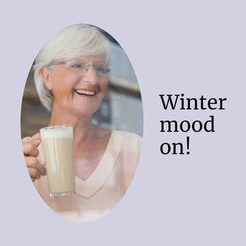 Composite of winter mood on text over caucasian woman drinking hot chocolate