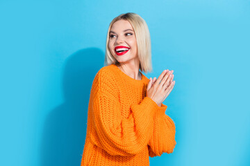 Portrait of lovely adorable woman with bob hairstyle dressed knitwear sweater look at empty space isolated on blue color background