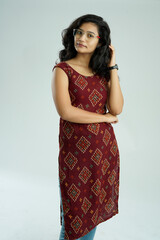 Pretty Indian young woman on white background.