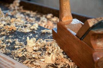 Close-up of a vintage wooden planer and sawdust - using traditional carpentry tools concept