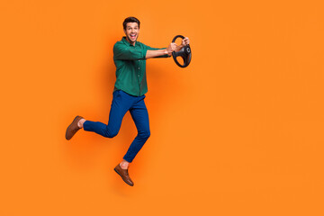 Full body photo of jumping businessman holding steering wheel crazy driver formalwear new lamborghini isolated on orange color background