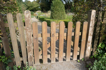 wooden fence in front of a garden