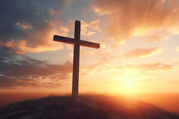 Fototapeta na wymiar Black cross religion symbol silhouette in the grass against a sunset or sunrise sky