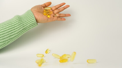 Dropping Omega-3-rich wild salmon and fish oil capsules against a gentle off-white background.