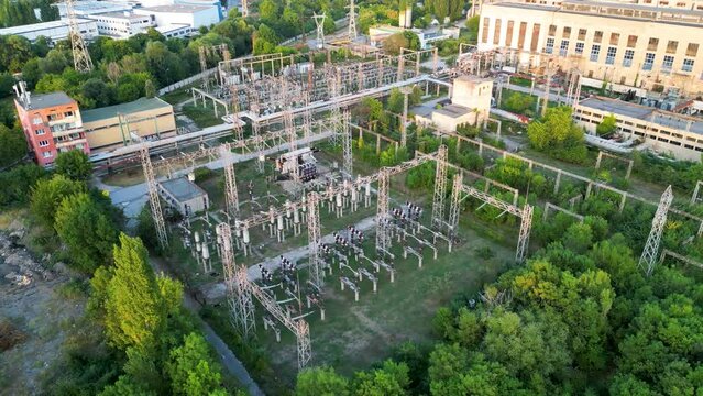 4k Aerial drone footage of an electricity substation in east europe. High angle shot of power transmission infrastructure.
