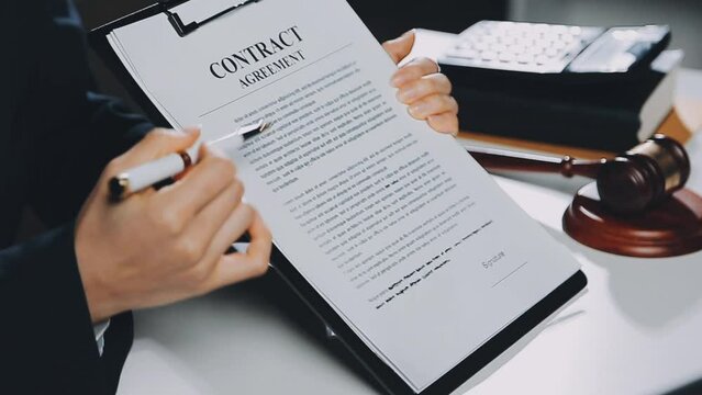 Business and lawyers discussing contract papers with brass scale on desk in office. Law, legal services, advice, justice and law concept picture with film grain effect