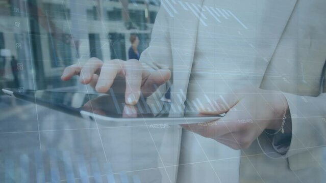 Animation of graphs, changing numbers, midsection of caucasian mam scrolling on digital tablet