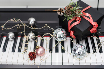 Piano keyboard with Christmas decoration, closeup.
