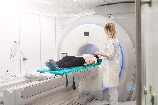 Female patient undergoing MRI - Magnetic resonance imaging in Hospital. Medical Equipment and Health Care