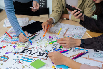 Team of ux developer and ui designer brainstorming interface wireframe design. Creative digital...