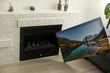 Canvas photo print on wooden floor. Sample of gallery wrapping method of canvas stretching on...