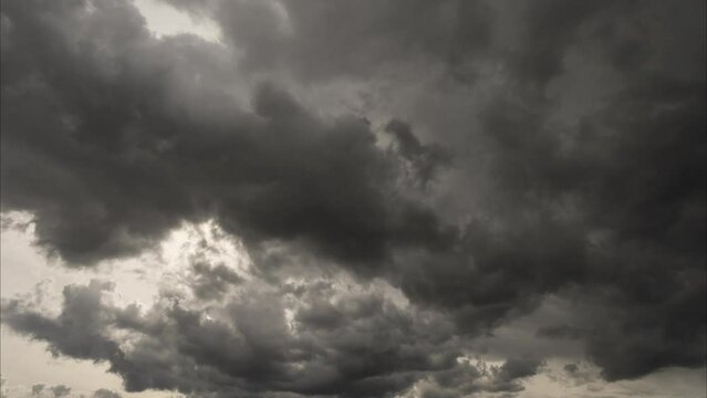 Timelapse of beautiful stormy cloudscape. Dark thunderstorm clouds moving fast high in sky background.
