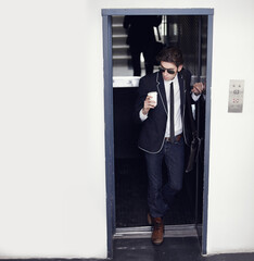 Coffee, fashion and young man in a doorway with stylish, cool or formal classy outfit with confidence. Latte, style and male person from Canada with elegant jeans and blazer in a office building.