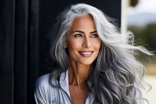 Generative AI photo of a attractive beautiful mature woman nice long healthy hair isolated on blurred grey background