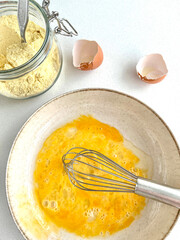 mixed egg yolk and jar of corn flour ingredients