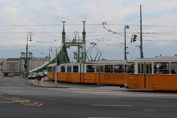 Yellow tram crossing the Liberty Bridge in Budapest, Hungary