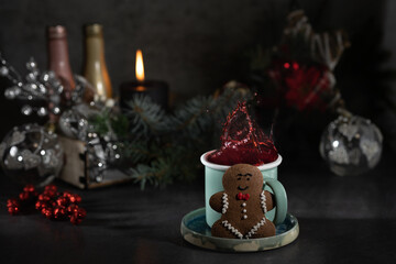 Decorating a Christmas composition with deer and a hot drink on a background, a place to copy and mug with splashes and drops of hot mulled wine at romantic moment