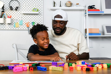 Father is Reading a Book to The Child. The Father is Helping The Child Develop Their Language Skills and Imagination. Father Fosters Language Skills in Child Through Storytelling.