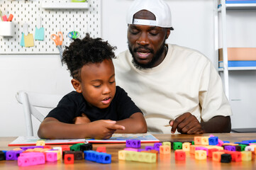 Father is Reading a Book to The Child. The Father is Helping The Child Develop Their Language Skills and Imagination. Father Fosters Language Skills in Child Through Storytelling.